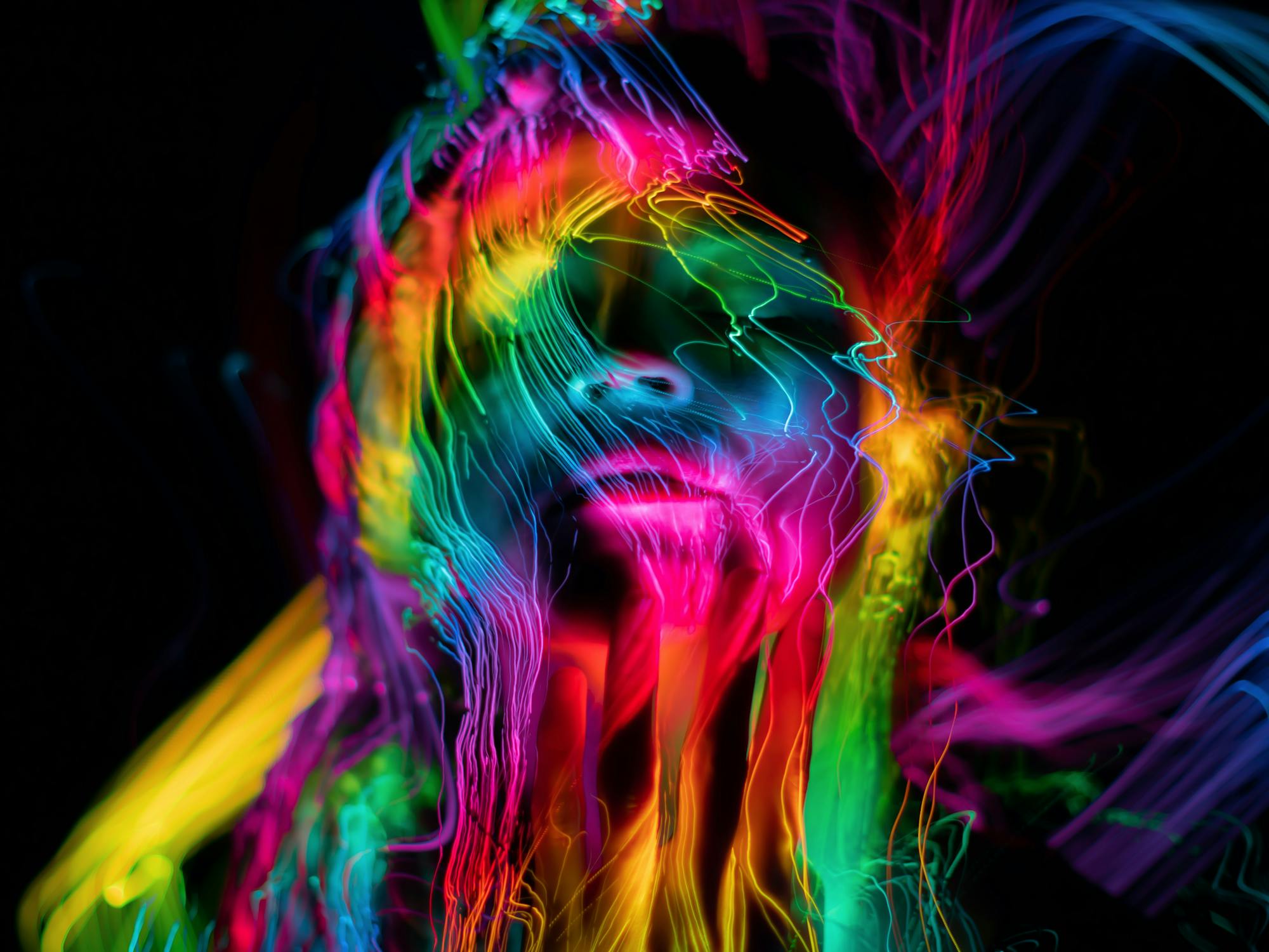 Abstract neon light painting dissolving into consciousness — ego dissolution neuroscience