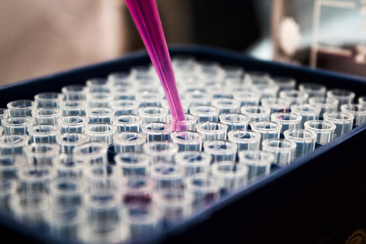 Two glass vials against dark laboratory background — ketamine and psilocybin molecular comparison